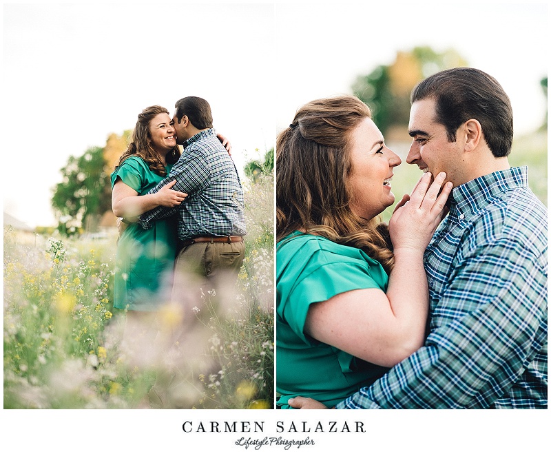kissing in flower field engagement photo