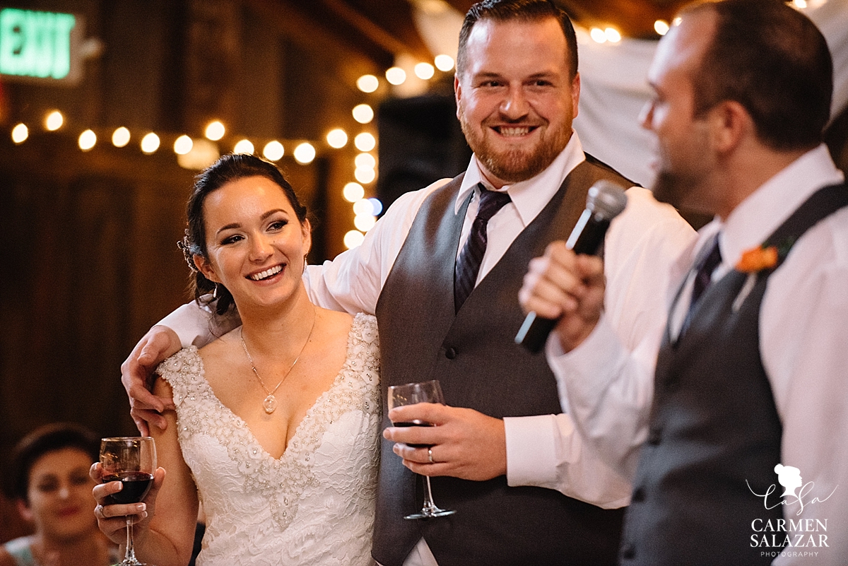 Happy couple during wedding speech - Carmen Salazar