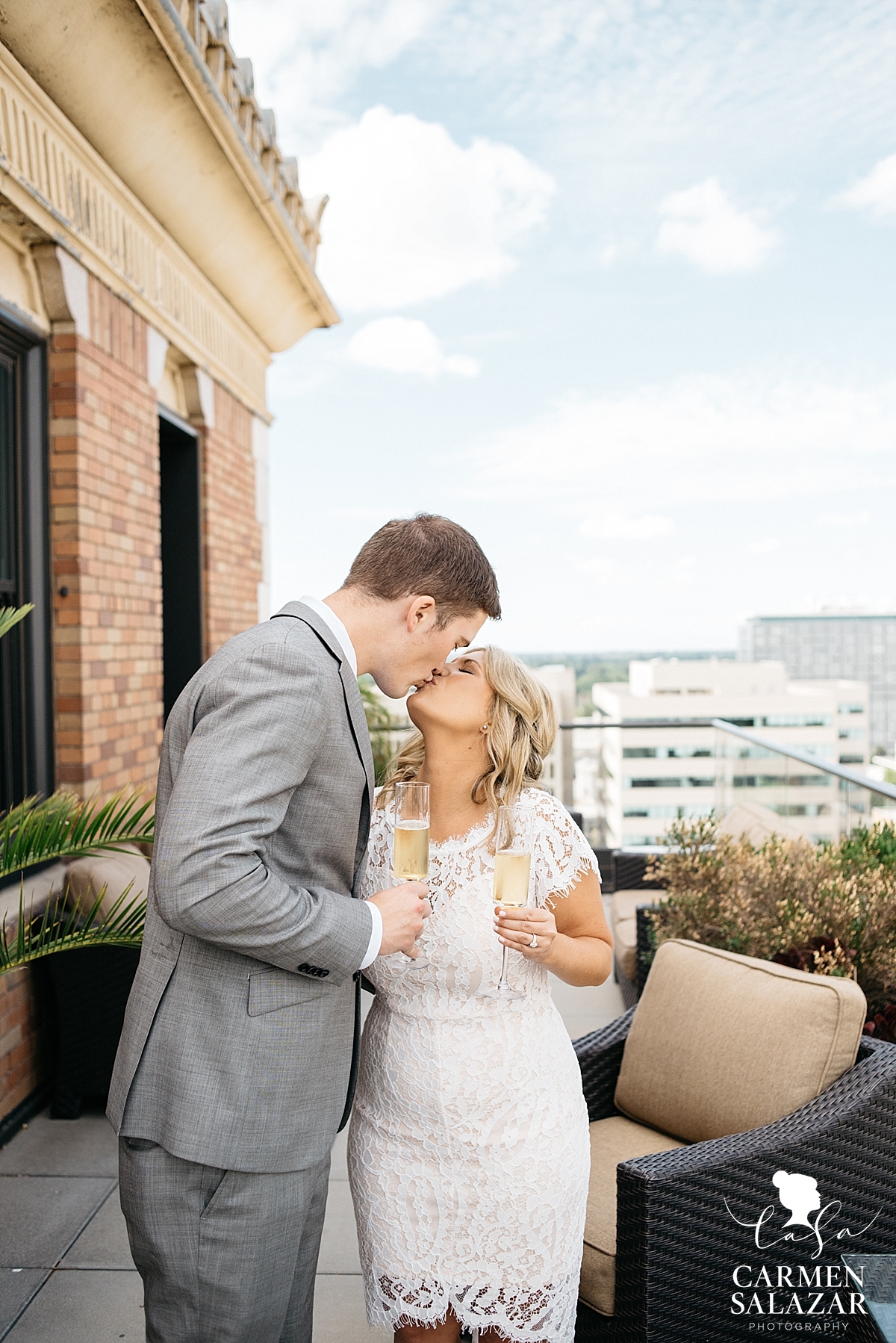 Bride and groom toasting at penthouse - Carmen Salazar