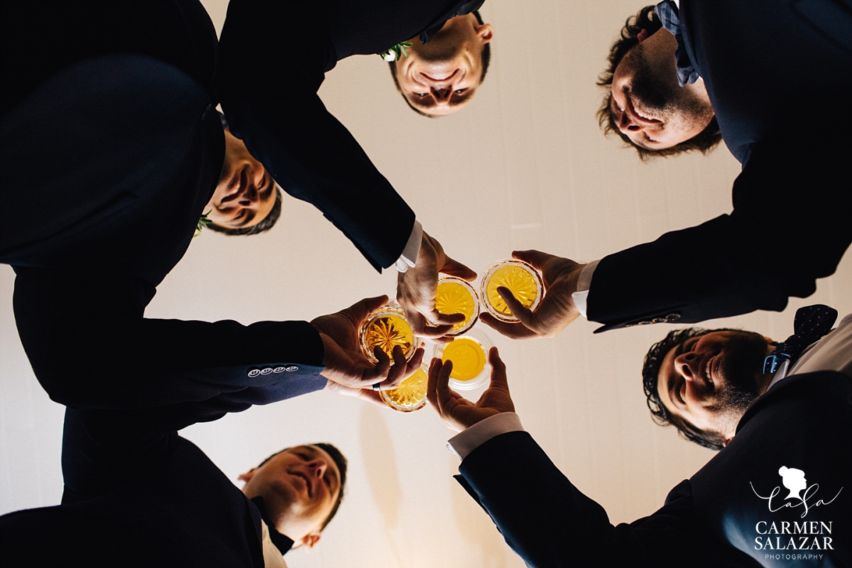 Groomsman toasting with scotch at a Summer Sacramento Wedding