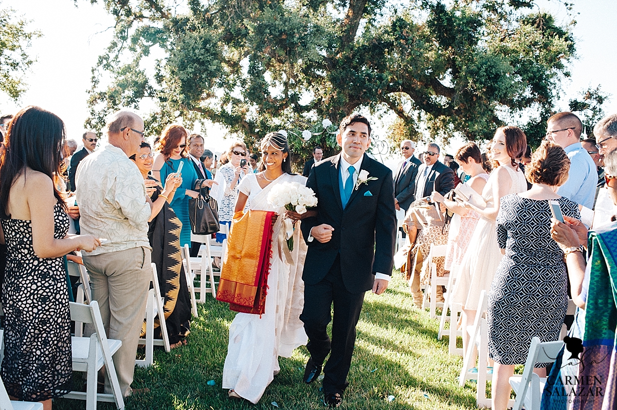 Newlyweds at Christian-Indian wedding ceremony - Carmen Salazar