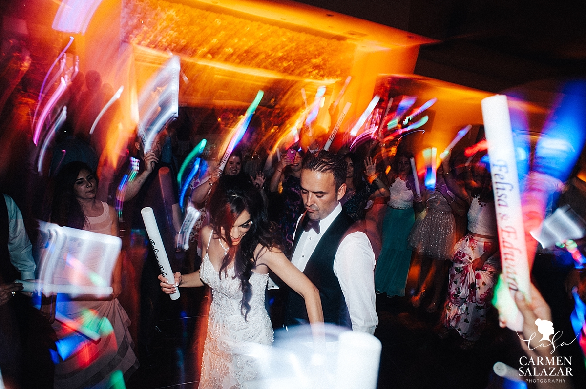 Bride and groom with custom glow sticks at Wine and Roses reception - Carmen Salazar