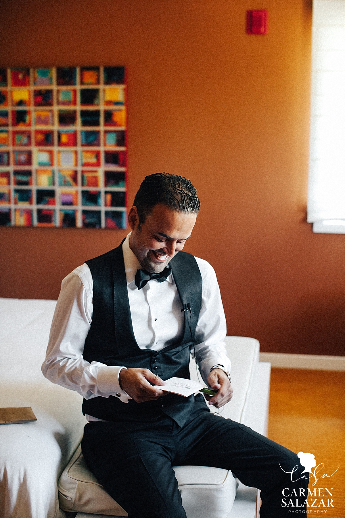 happy groom reading love note from bride at Lodi wedding