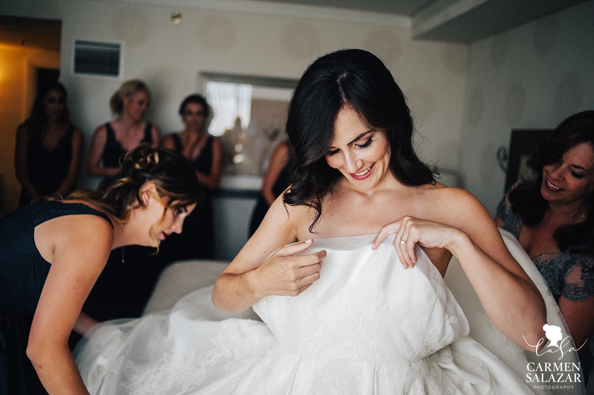 Bride putting on gown at Fairmont - Carmen Salazar