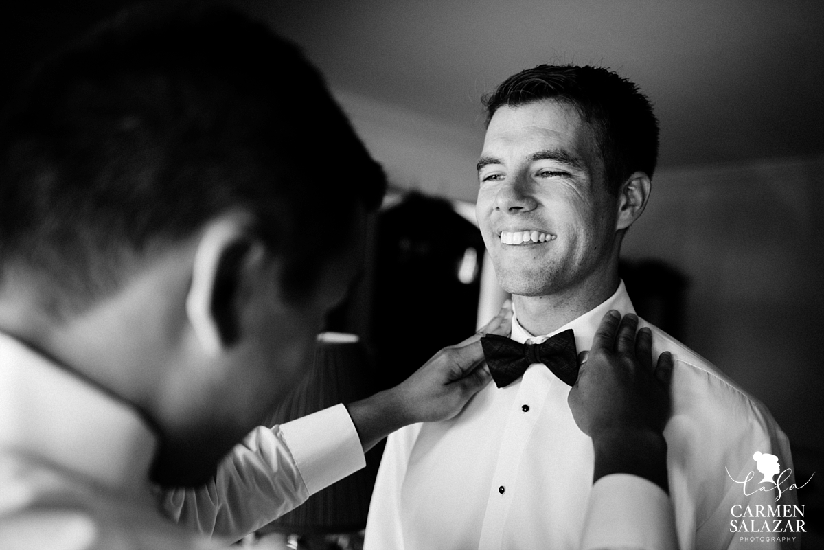 Classic groom putting on bowtie - Carmen Salazar