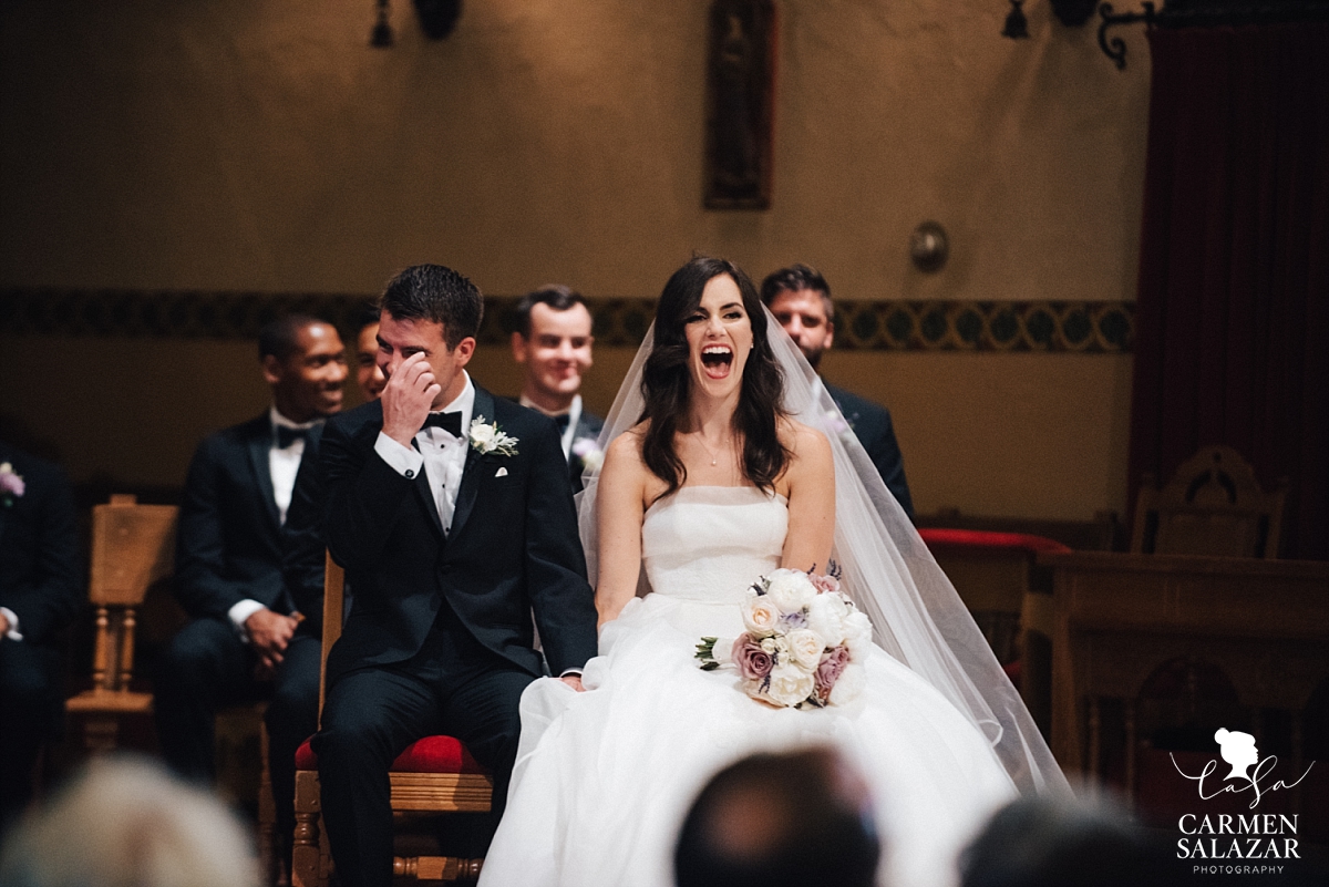 Laughing bride and groom at Catholic ceremony - Carmen Salazar