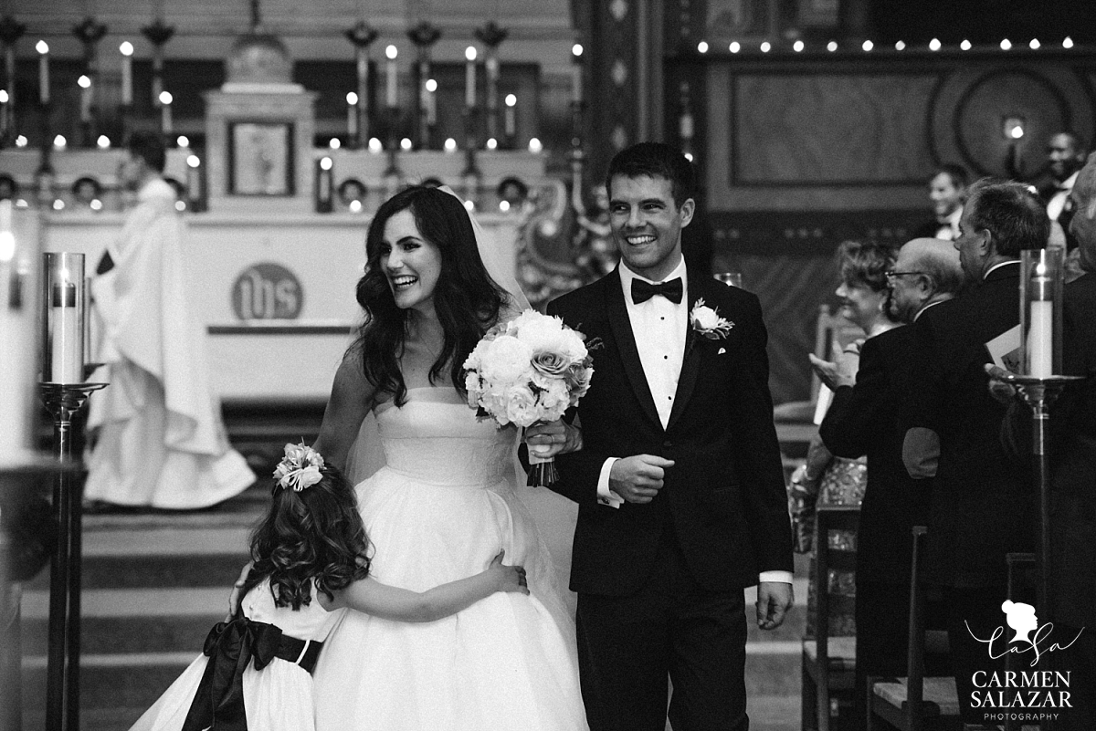 Happy newlyweds walking down aisle - Carmen Salazar