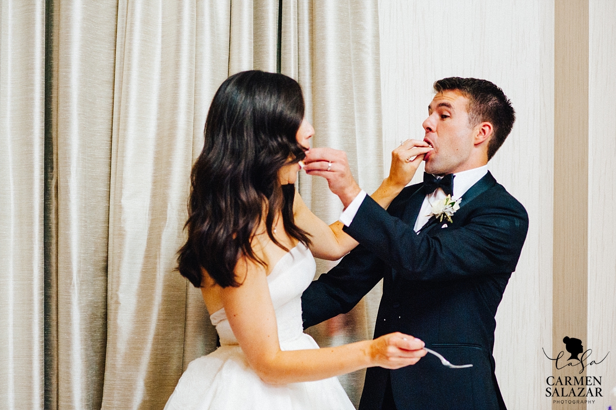 Bride and groom tasting wedding cake at Westin - Carmen Salazar