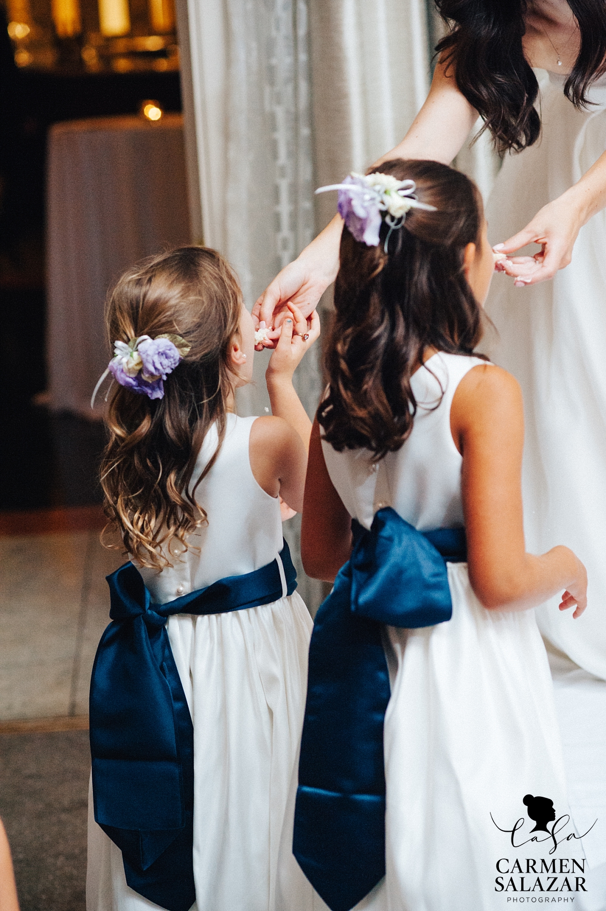 Bride feeding flower girls wedding cake - Carmen Salazar