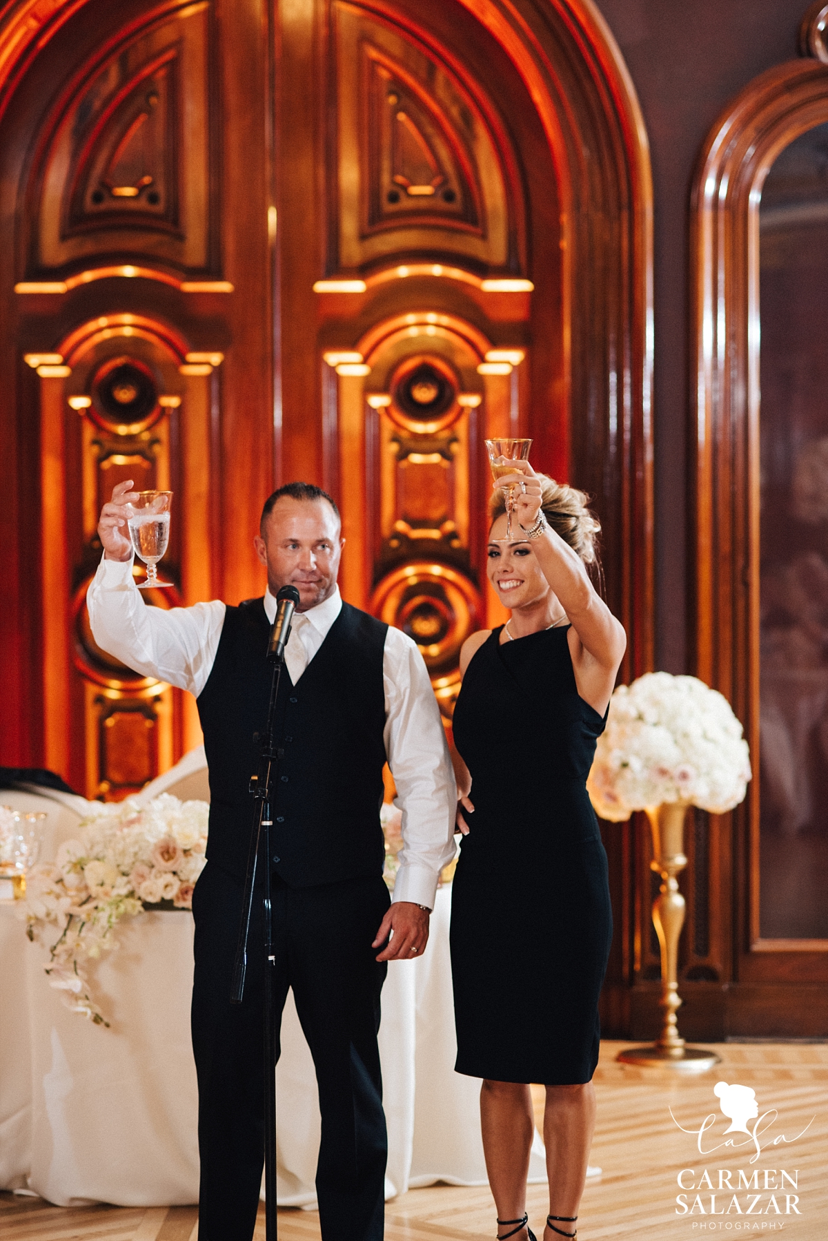 Bride and groom toasting at art museum reception - Carmen Salazar