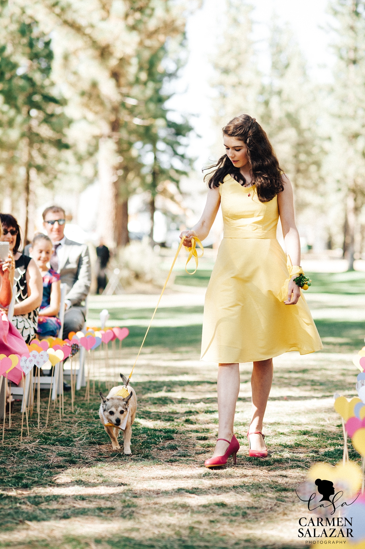 Bright junior bridesmaid walking dog down wedding aisle - Carmen Salazar