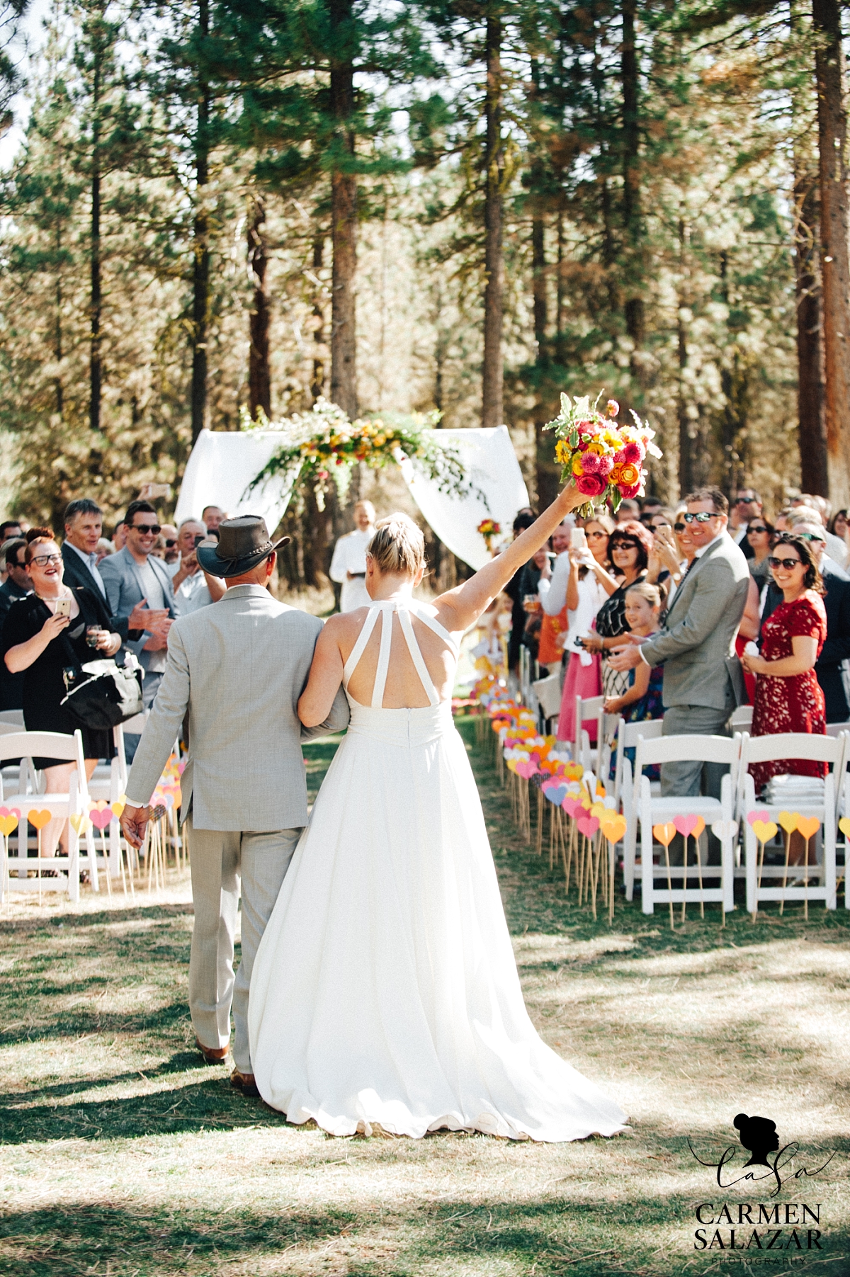 Excited bride walking down the aisle at Chalet View Lodge wedding - Carmen Salazar