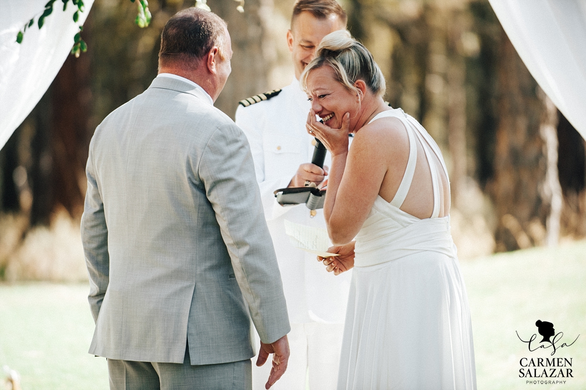 Laughing bride at outdoor ceremony - Carmen Salazar