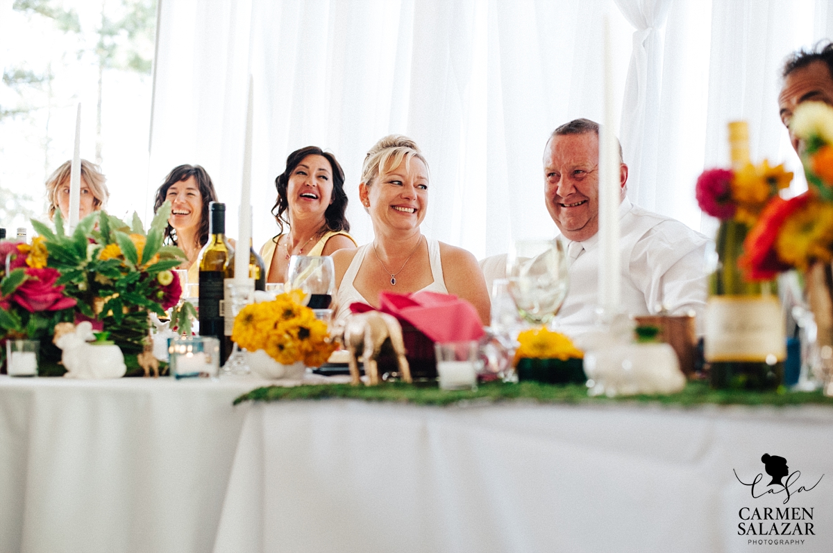 Happy bride and groom at DIY design head table - Carmen Salazar