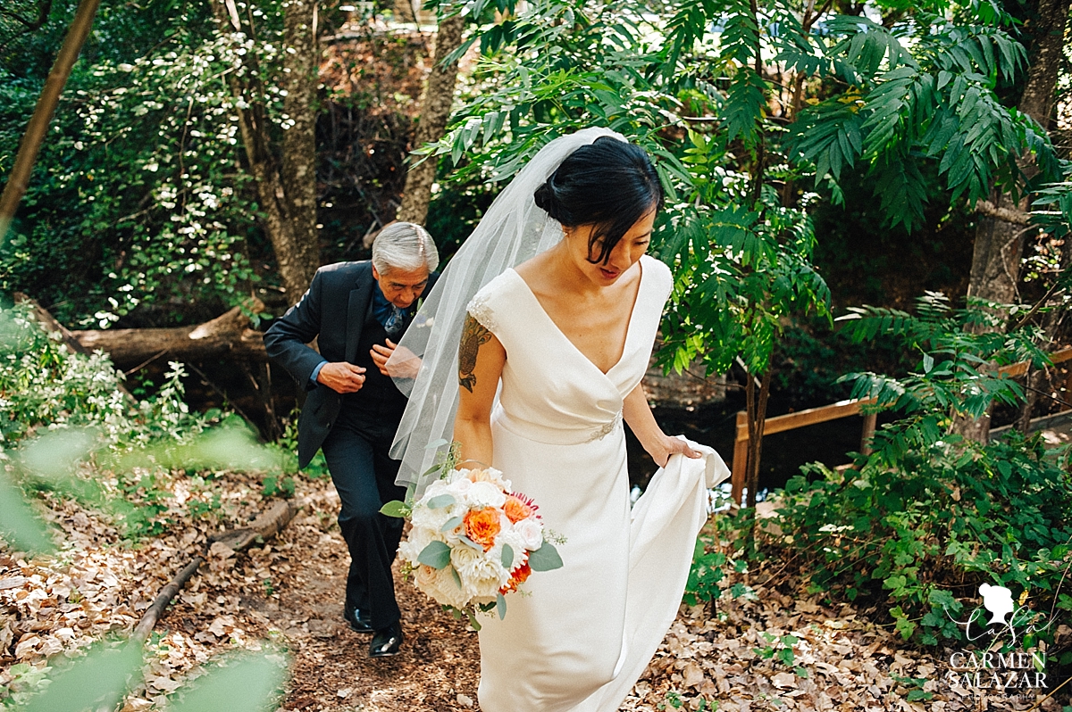 Bride crossing rustic bridge to the ceremony - Carmen Salazar