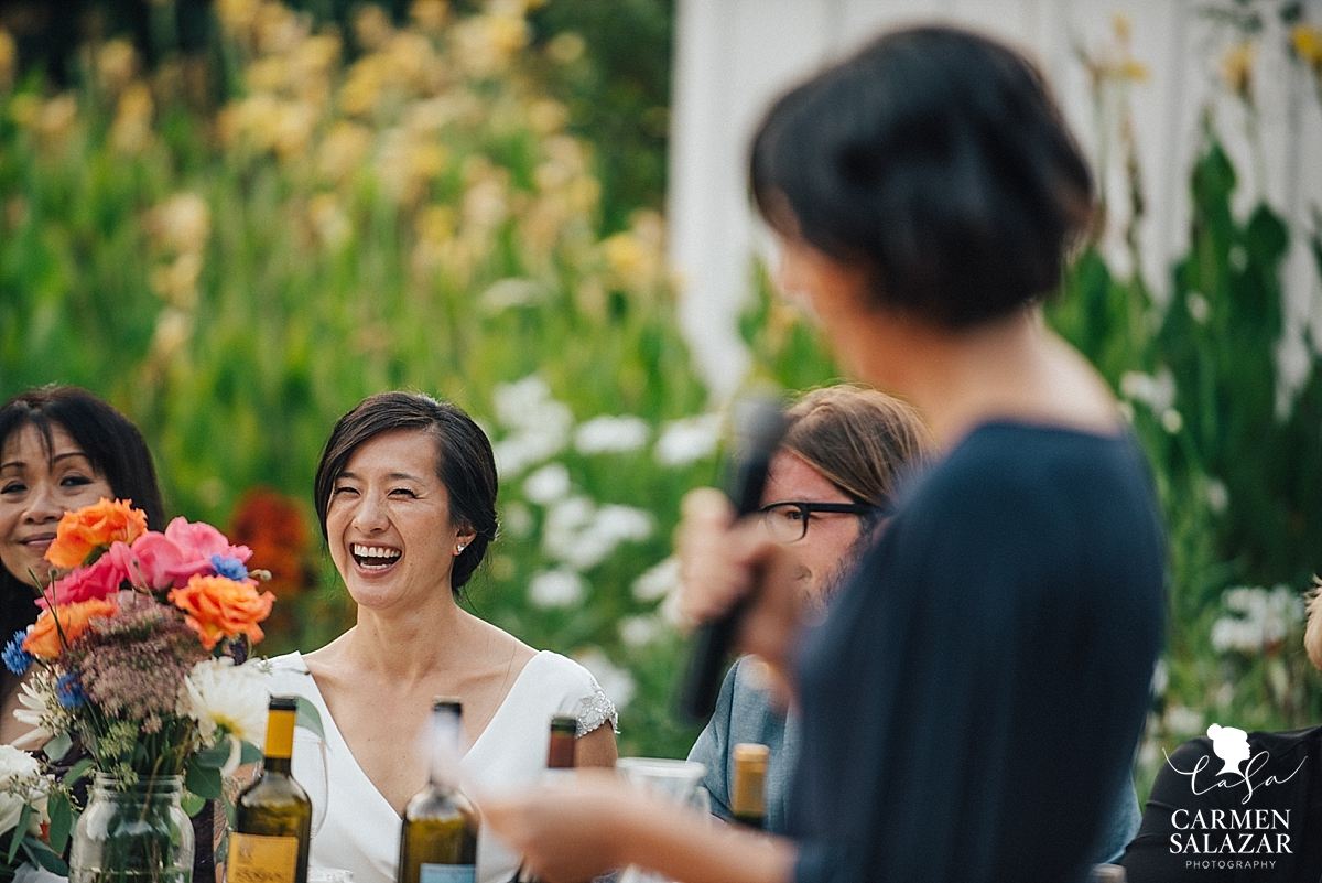 laughing bride during wedding toast and speech by Maid of honor - Carmen Salazar