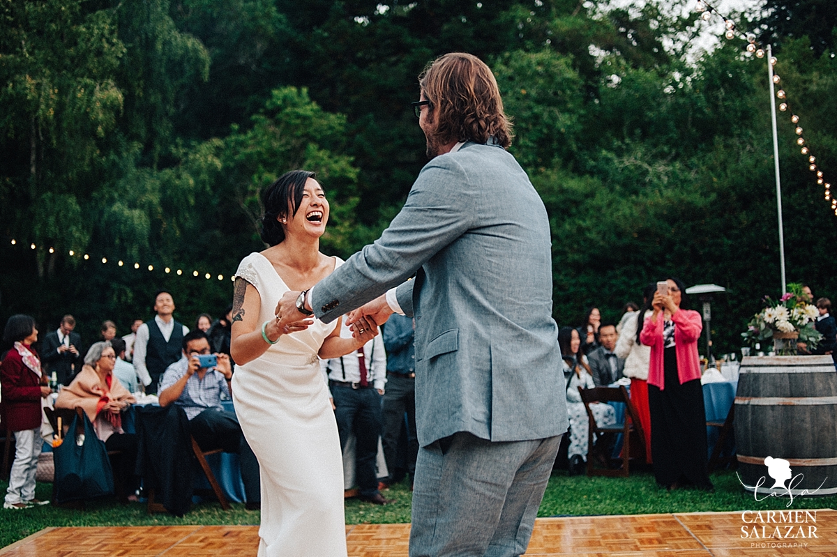 laughing bride at Sunset first dance at Santa Cruz outdoor wedding - Carmen Salazar