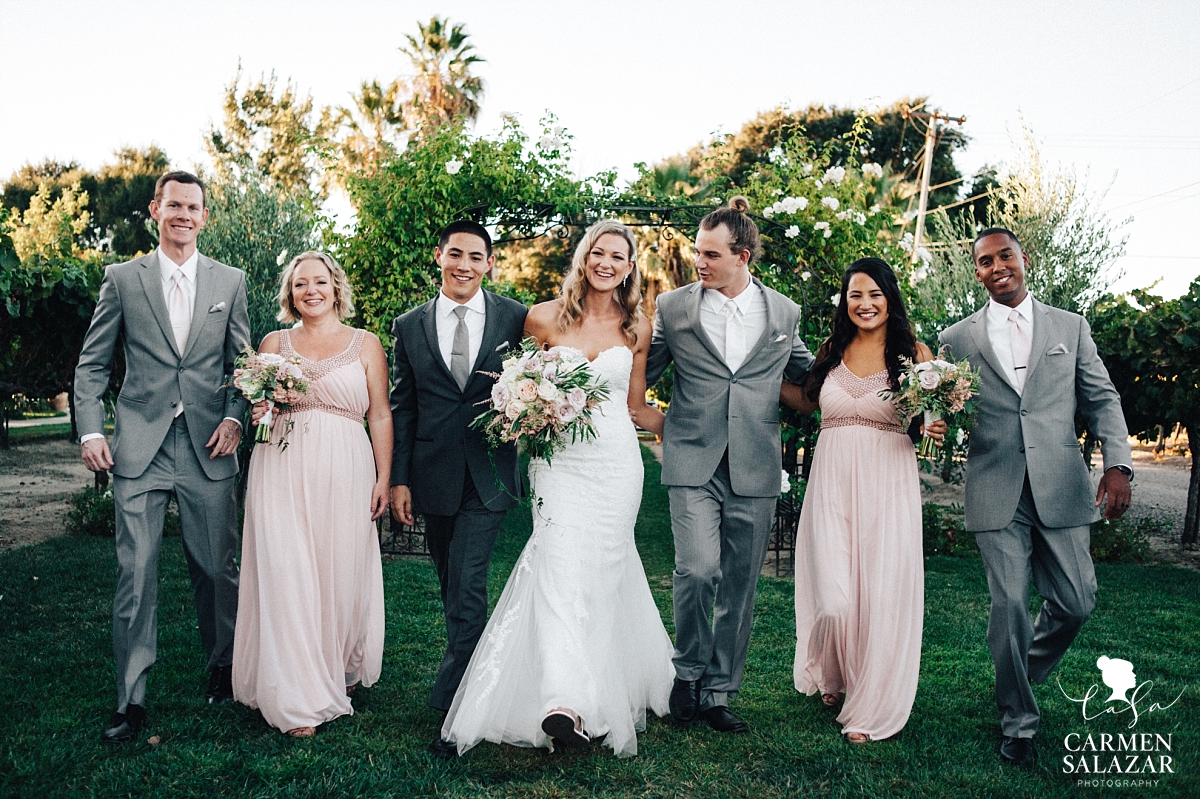 Wedding party walking through winery garden - Carmen Salazar