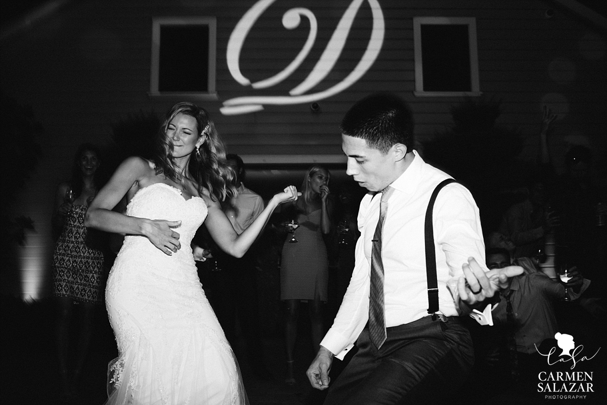 Bride and groom air guitar on the dance floor - Carmen Salazar