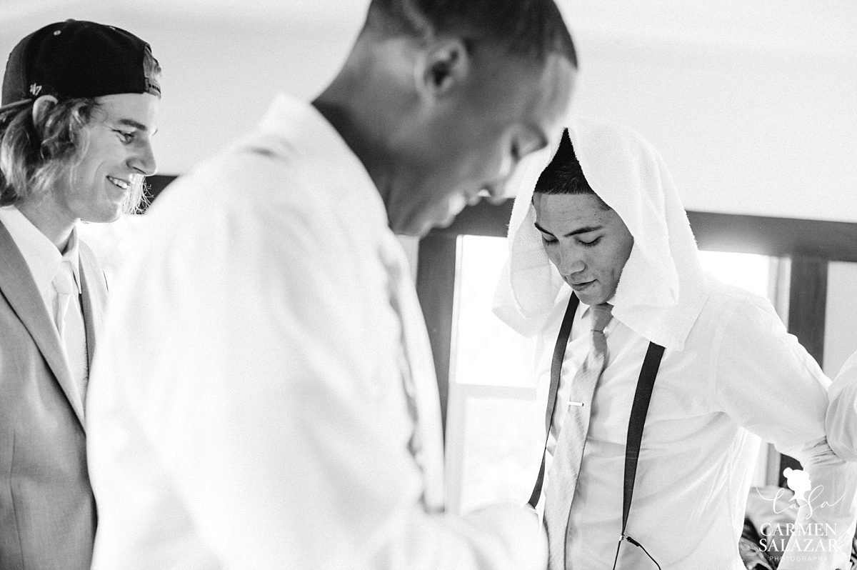 Groom cooling off while getting dressed with groomsman - Carmen Salazar