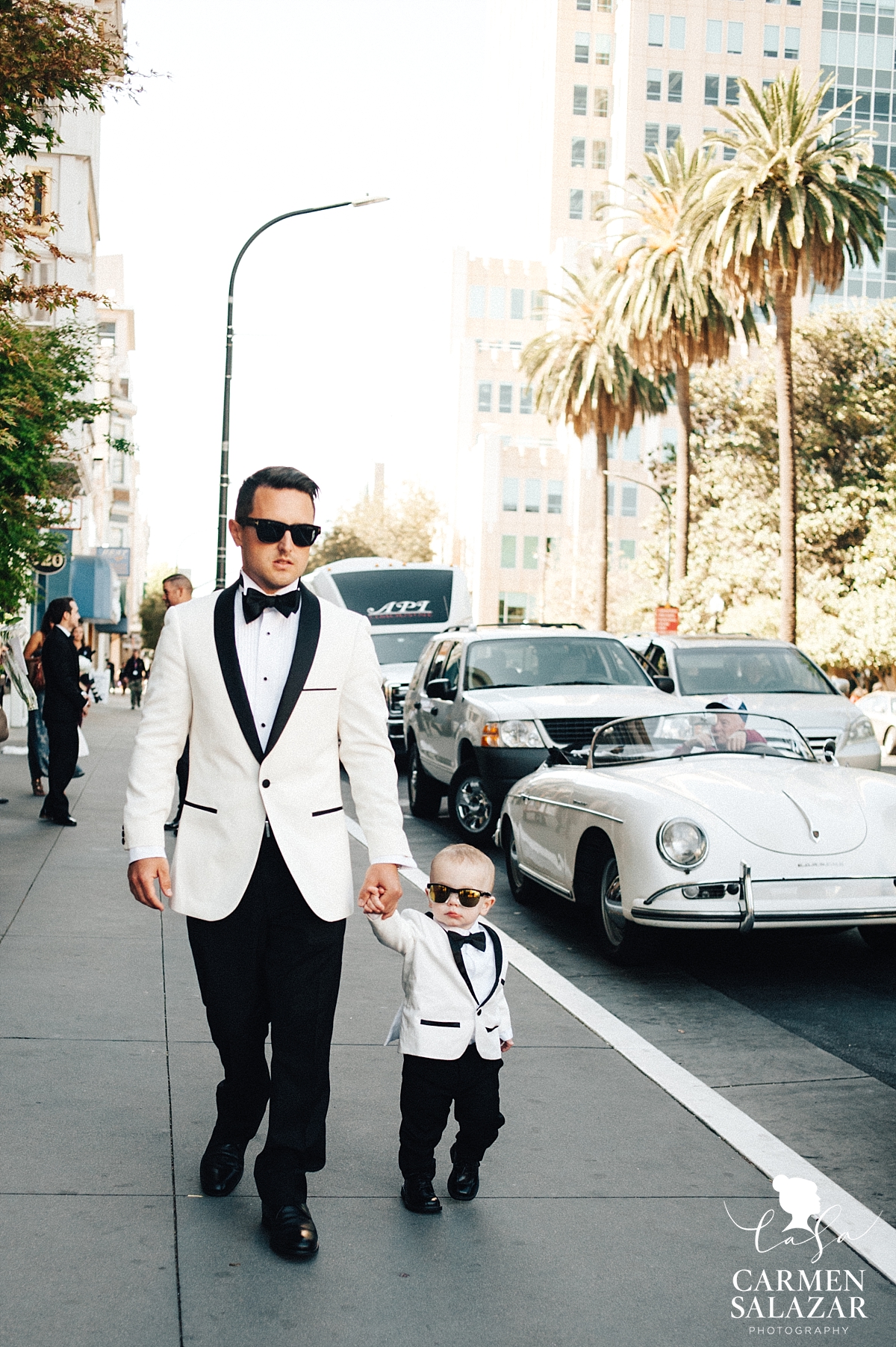 Cool groom and toddler son walking to wedding - Carmen Salazar