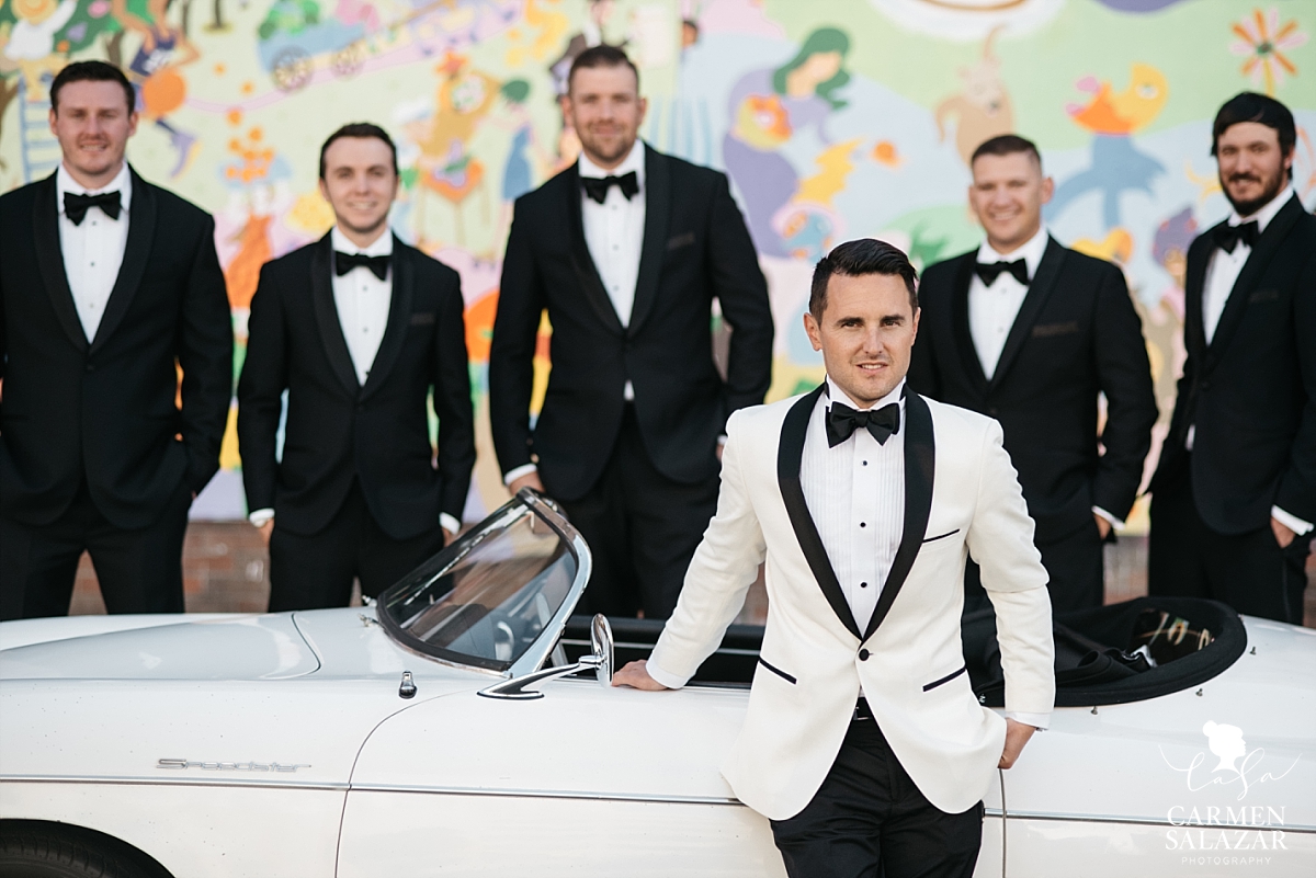 Groom and groomsmen posing with vintage Porsche - Carmen Salazar