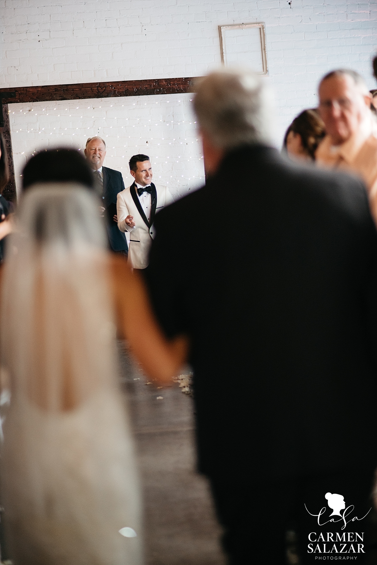 Grinning groom excited to see his bride - Carmen Salazar