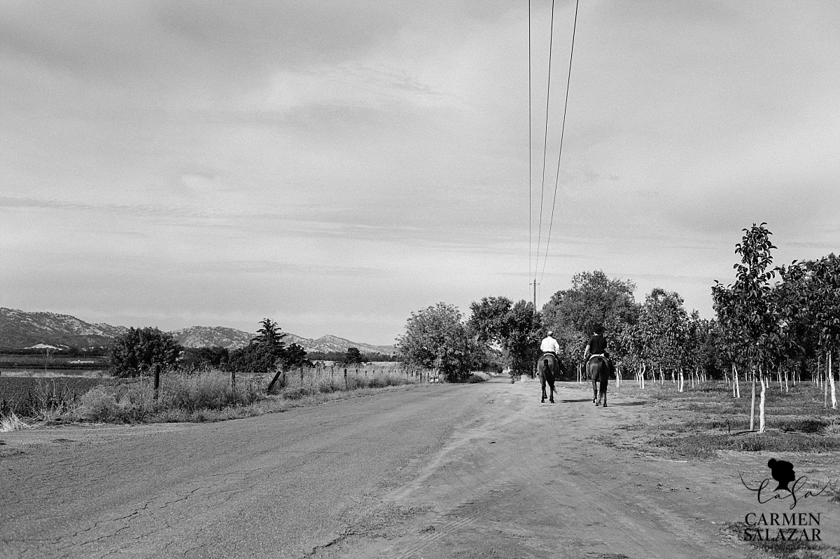 Father of the groom riding horses with son - Carmen Salazar