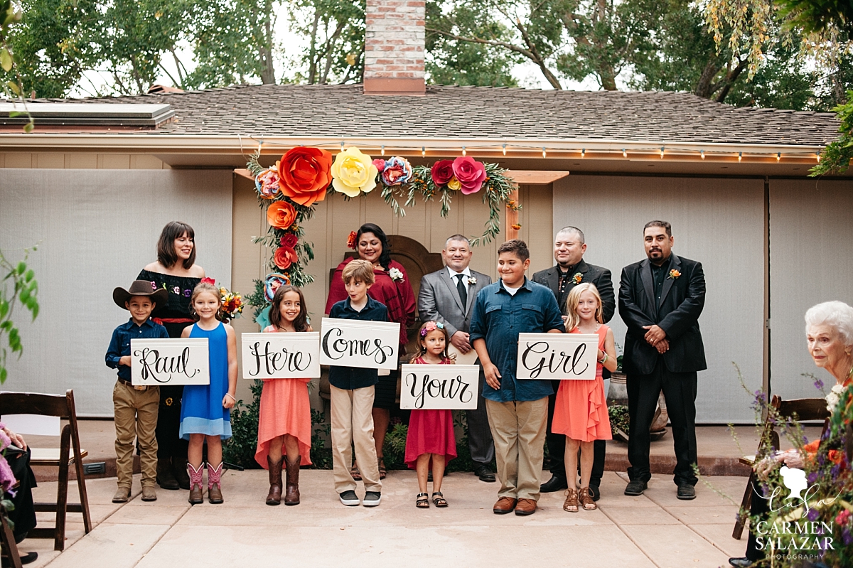 DIY wedding aisle signs with adorable bearers - Carmen Salazar