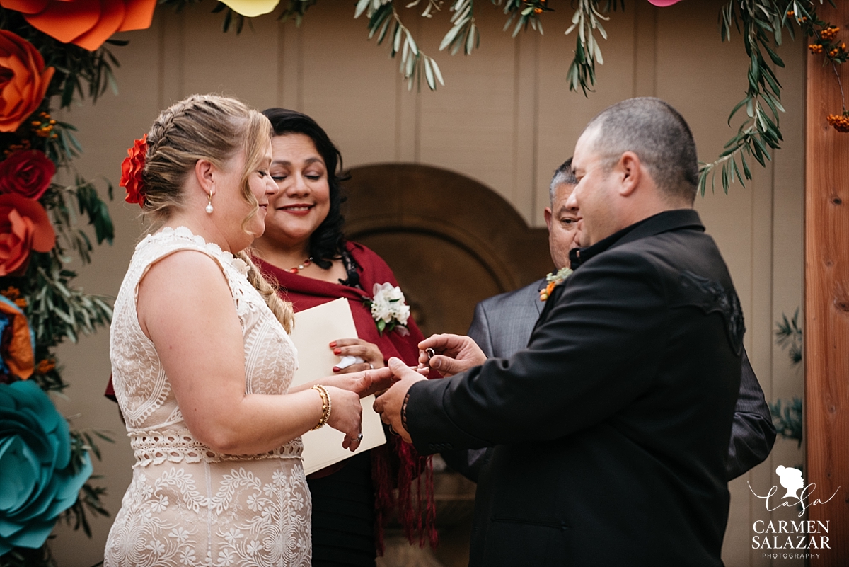 Groom puts ring on bride at Winters private estate wedding - Carmen Salazar