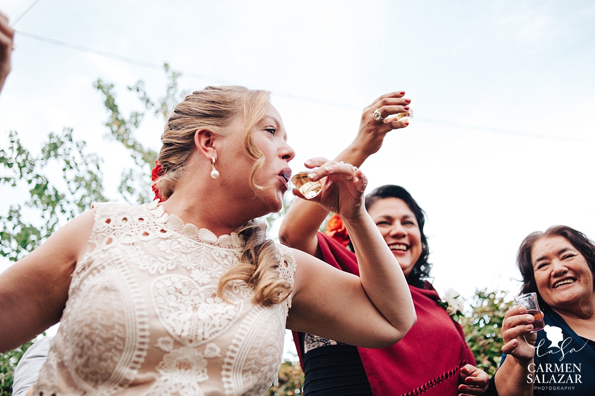 Bride sipping tequila with in-laws after ceremony - Carmen Salazar