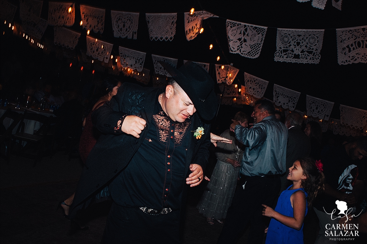 Cowyboy groom dancing at outdoor reception - Carmen Salazar