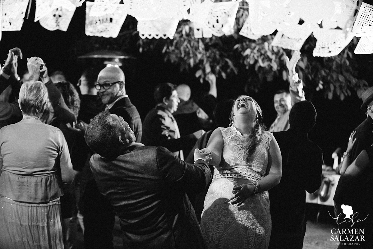 Laughing bride dancing at private estate wedding - Carmen Salazar