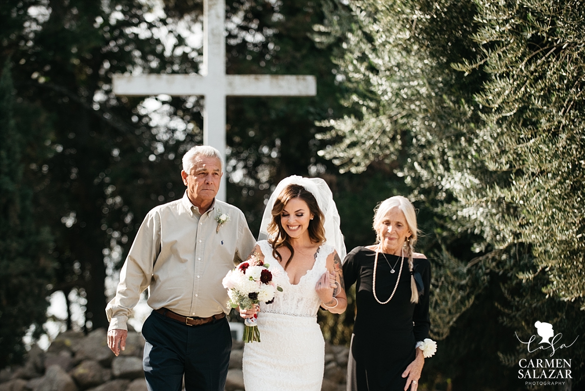 Bride walking with parents at Our Lady of Sorrows Chapel - Carmen Salazar