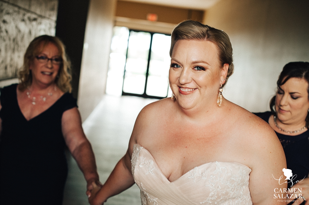 Beaming bride putting on gown at Leer Vineyards - Carmen Salazar