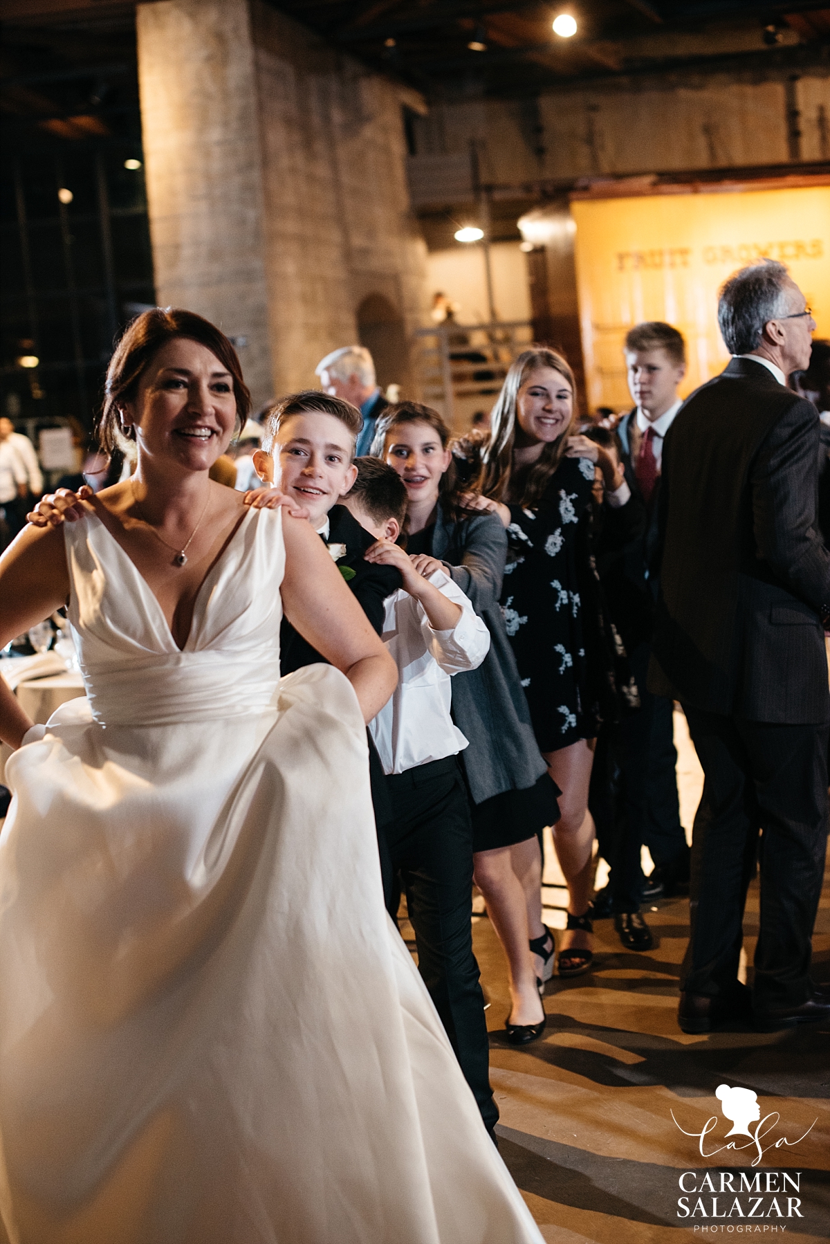 Conga line at Sacramento museum wedding - Carmen Salazar