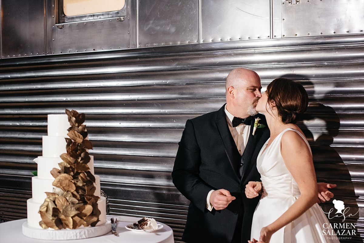 Newlyweds smooch at cake cutting - Carmen Salazar