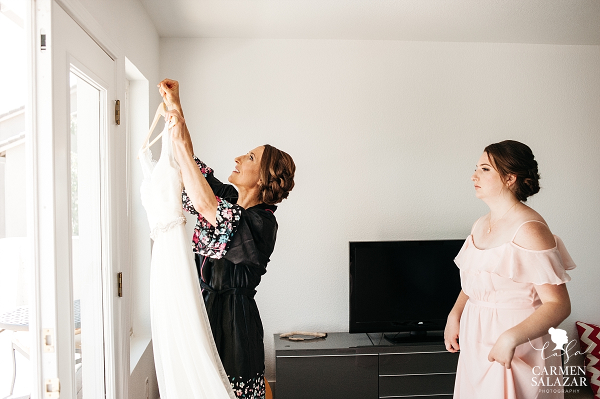 Bride and daughter grabbing wedding gown - Carmen Salazar