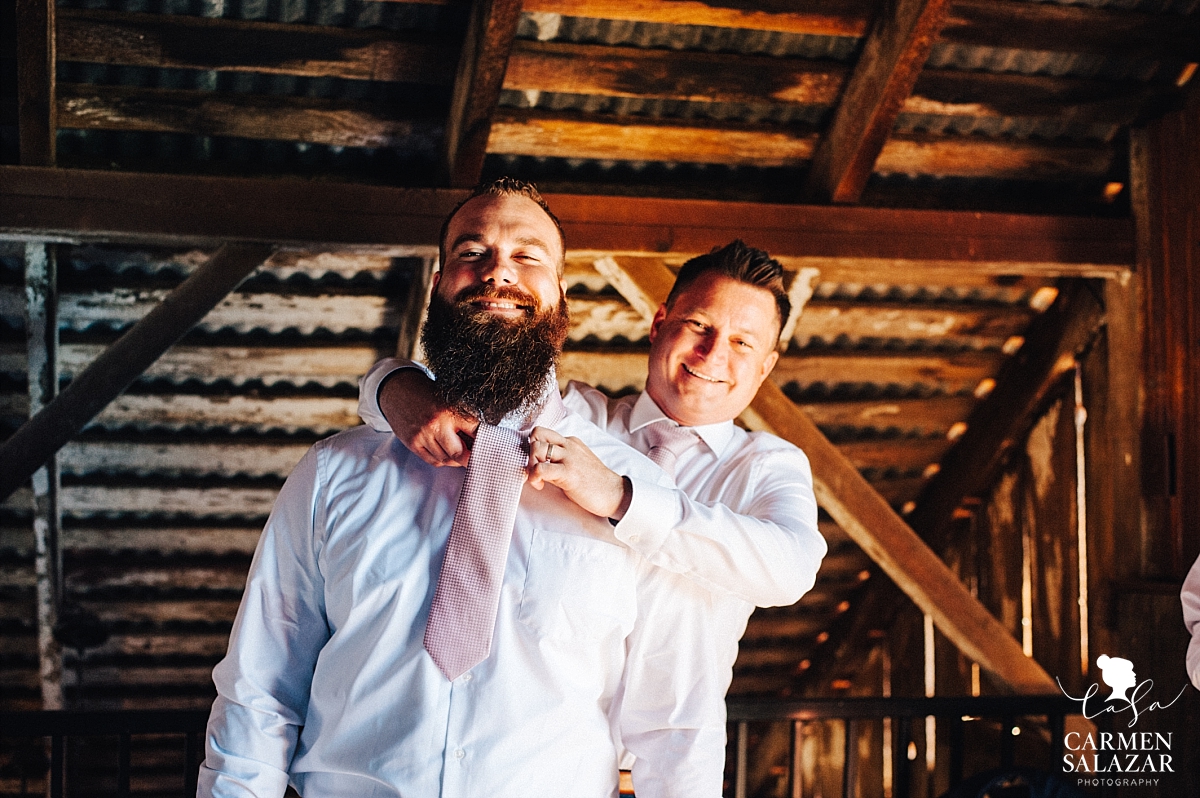 Happy groomsmen getting ready in barn - Carmen Salazar 