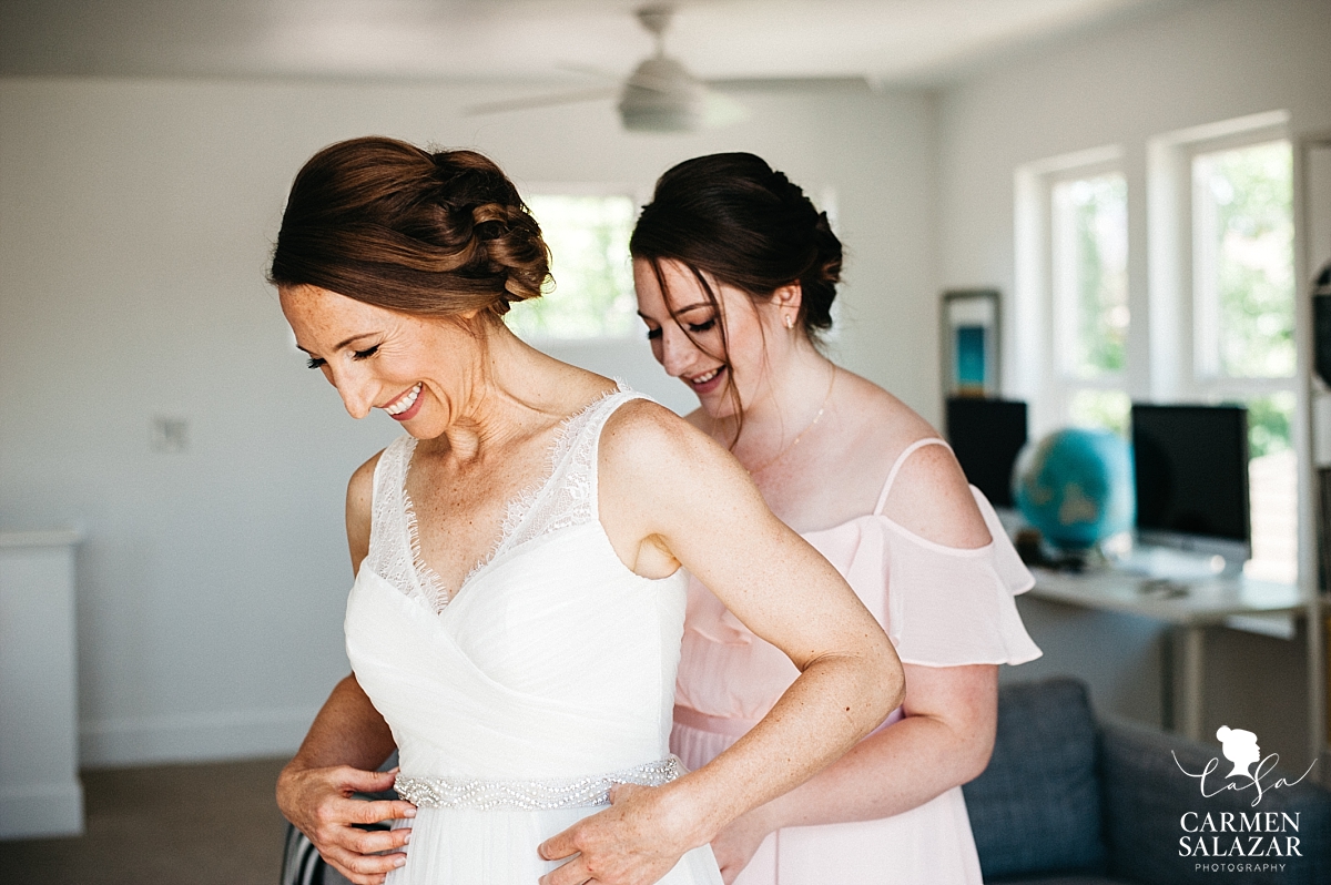 Glowing bride and daughter getting ready - Carmen Salazar