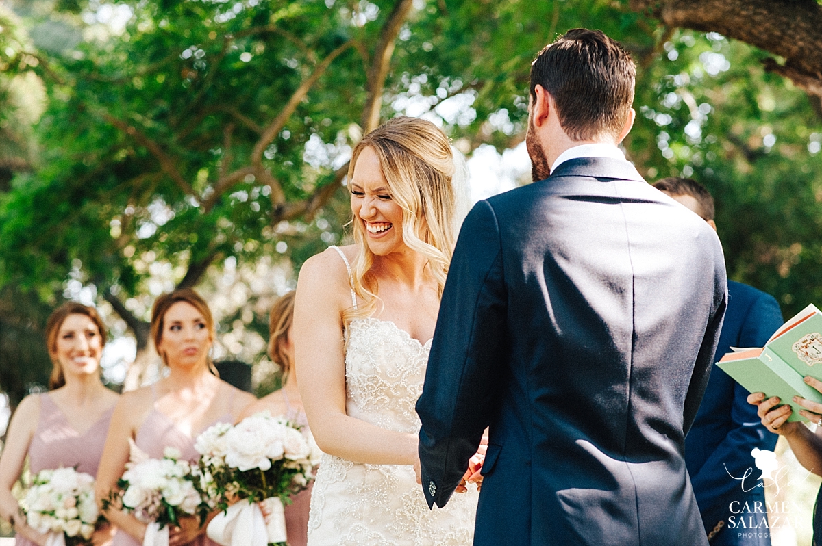 Bride giggling at groom's wedding vows - Carmen Salazar