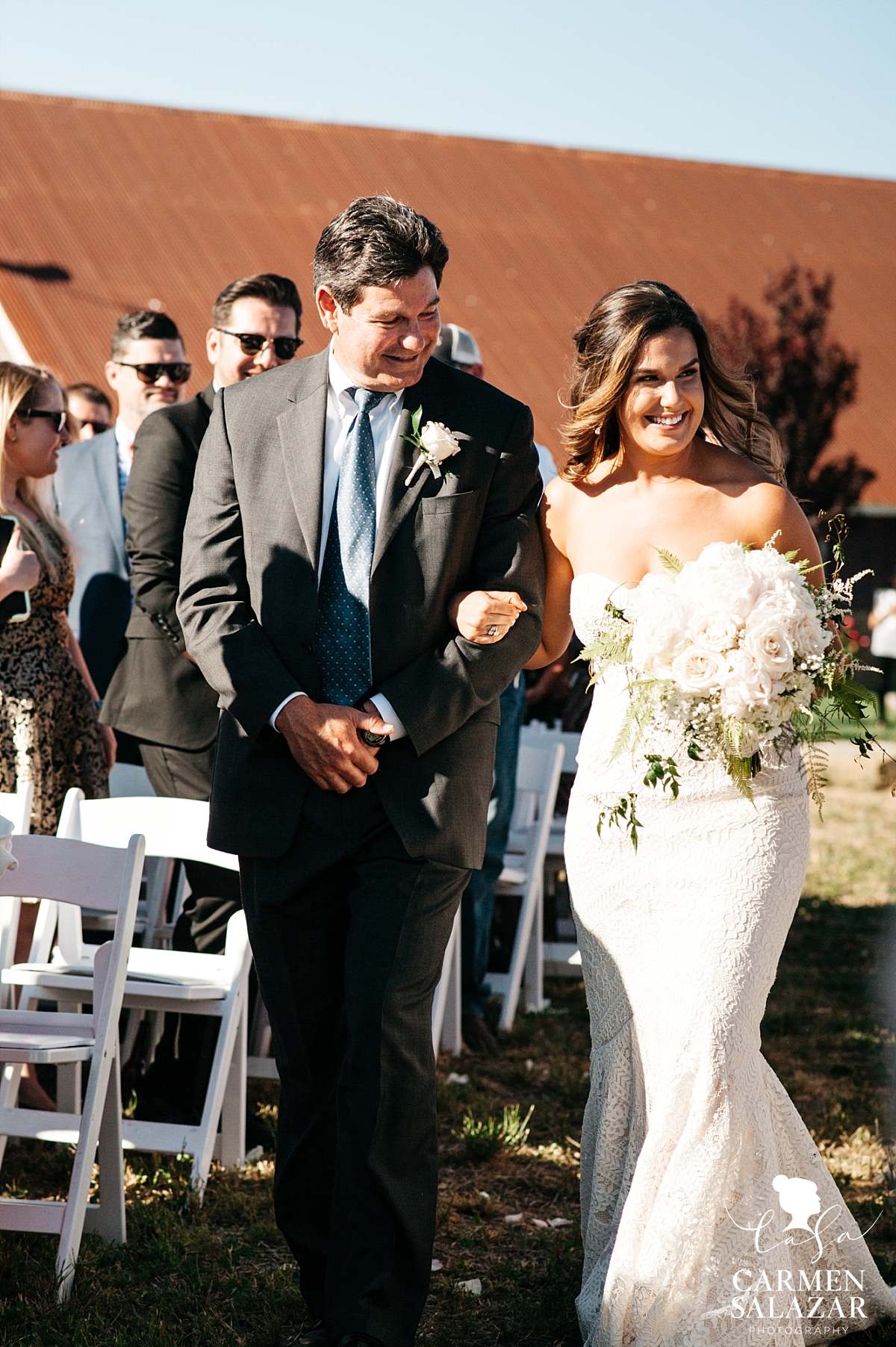 Barn wedding bride walks the aisle - Carmen Salazar 