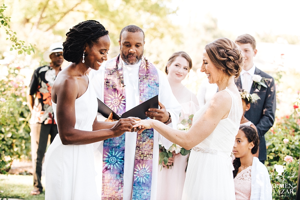 Brides exchange wedding rings at McKinley Rose Garden - Carmen Salazar