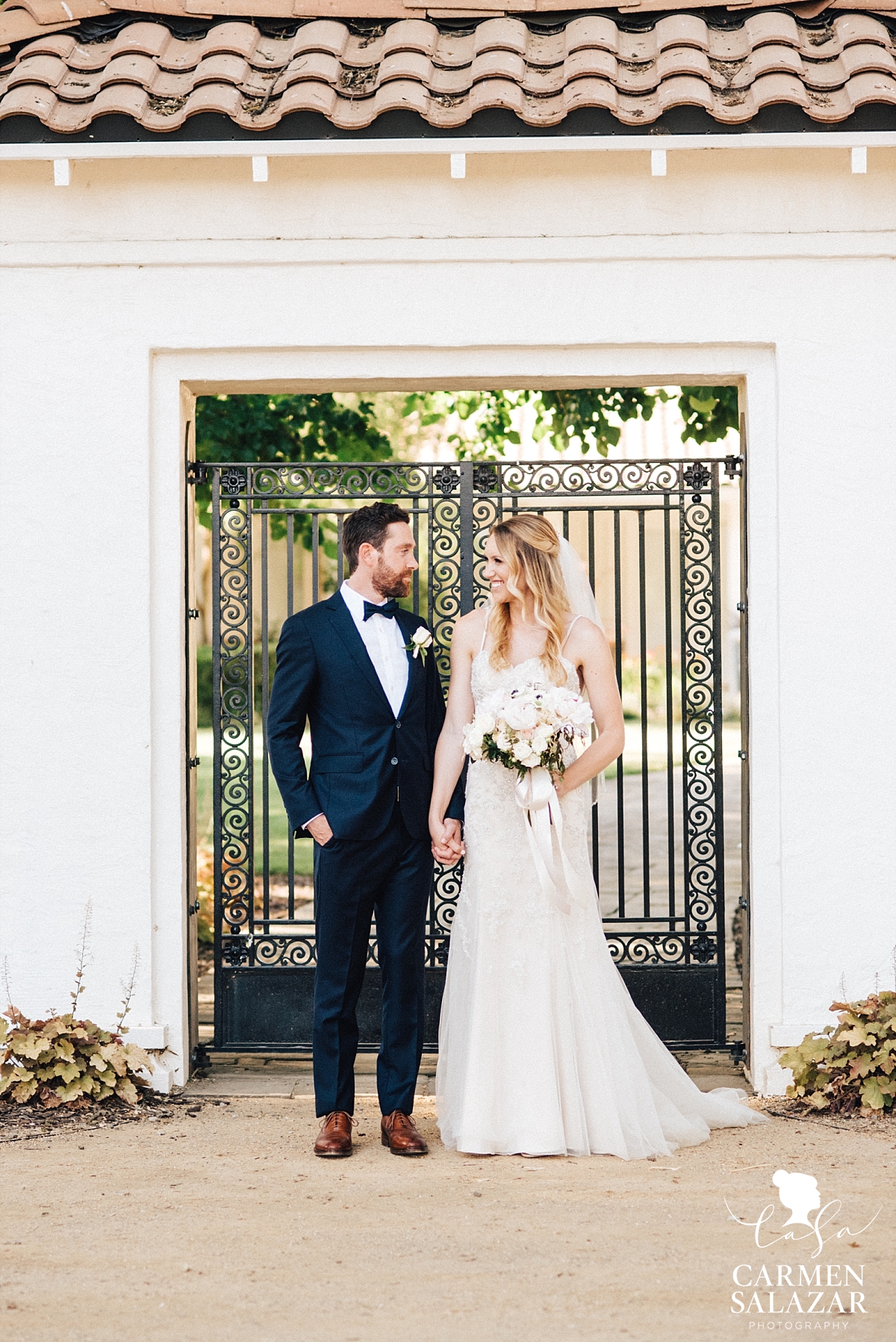 Bride and groom outside The Maples entrance - Carmen Salazar