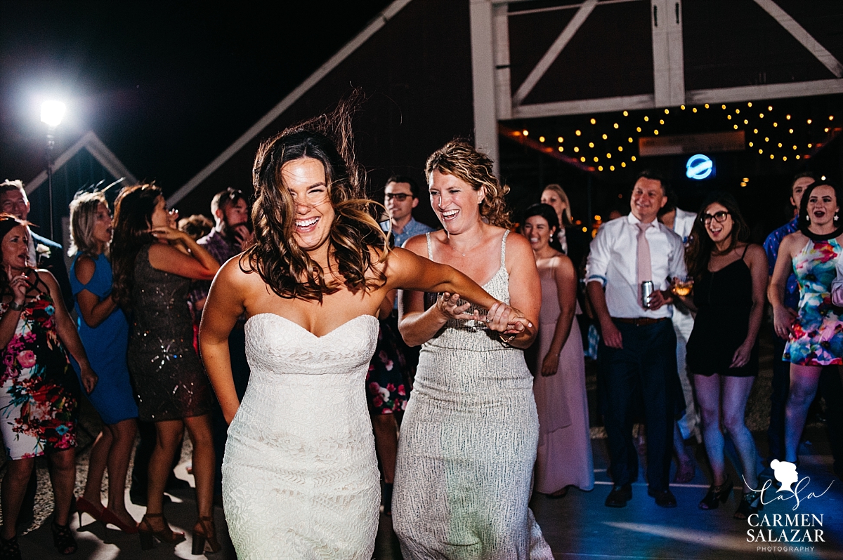 Bride and bridesmaid tearing up the dance floor - Carmen Salazar 