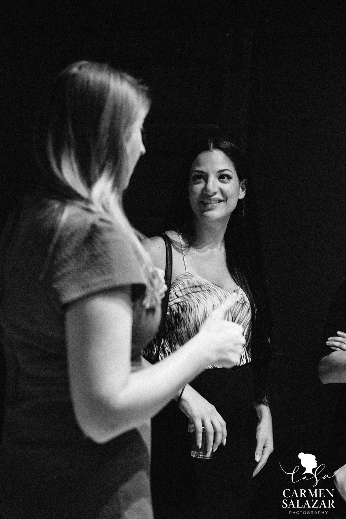 Black and white picture of women talking at party with Sacramento event photographer Carmen Salazar