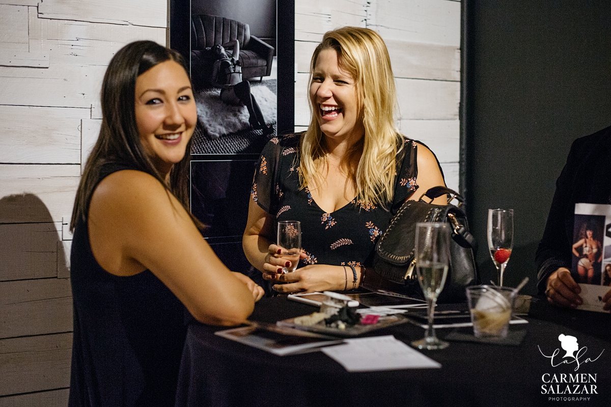 two women laughing together at VIP party with Sacramento event photographer Carmen Salazar