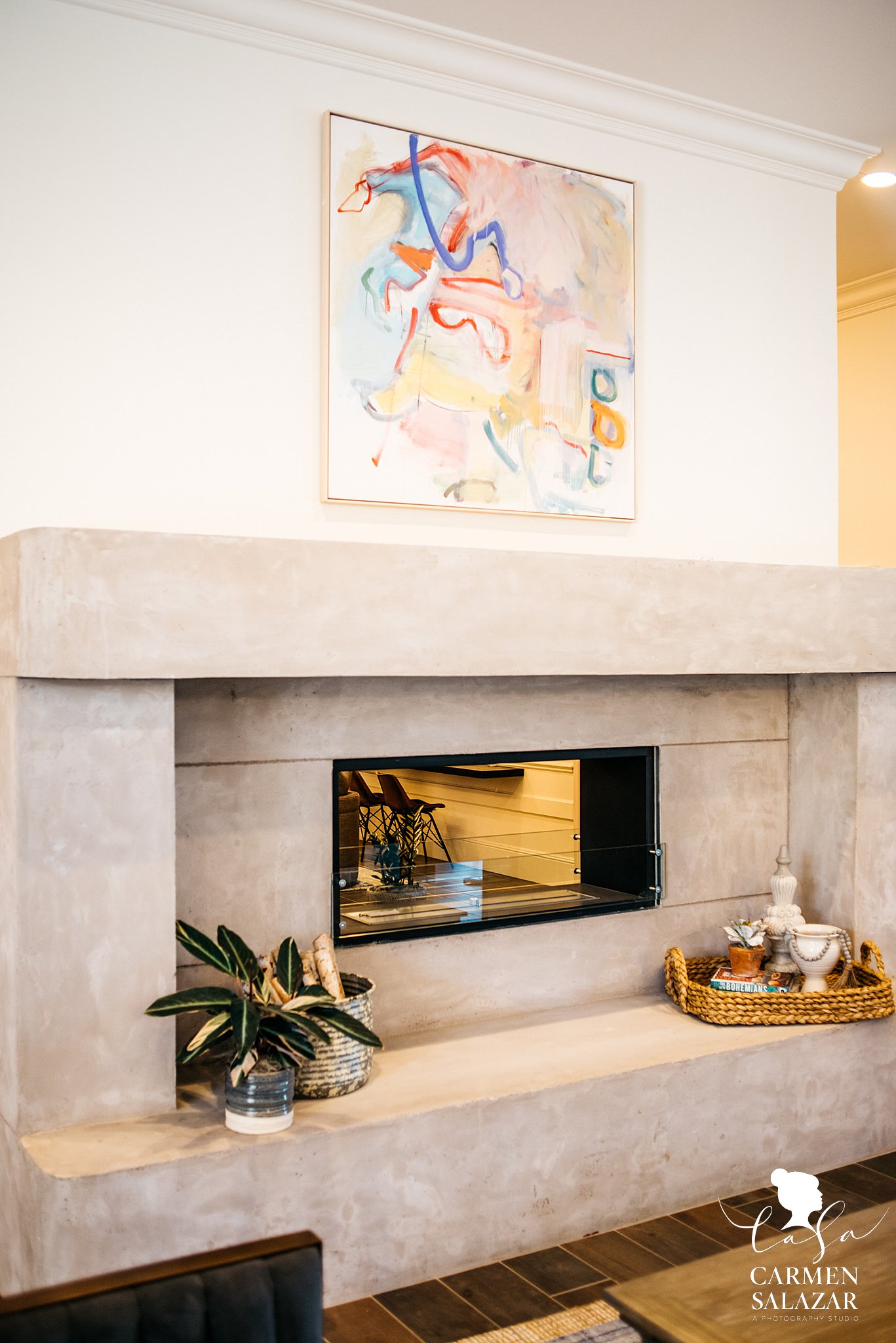 Modern fireplace with expressionist art above mental 