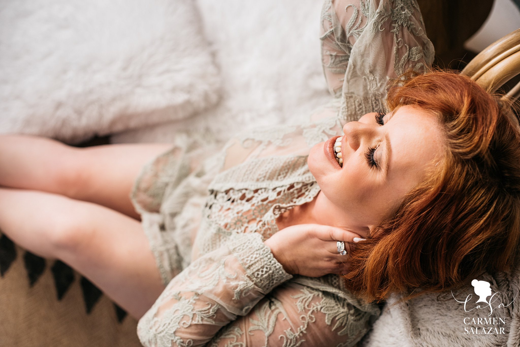 Smiling boudoir picture of beautiful women sitting on a carpet 